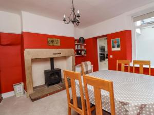 a dining room with a table and a fireplace at Victoria House in Alnwick