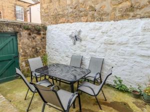 a table and chairs with a butterfly on a wall at Victoria House in Alnwick