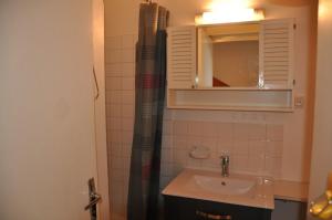 a bathroom with a sink and a shower curtain at Olympe - 124 - Studio coquet - 3 pers in Les Deux Alpes