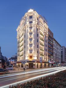 a large white building on a city street at night at Perla Pura in İzmir