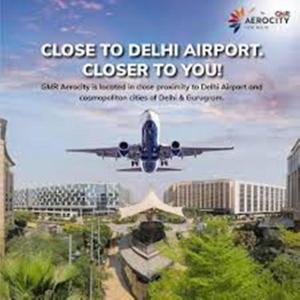 an airplane is flying in the sky over a city at Aerocity Hotel Zindal Plaza at Delhi Airport in New Delhi