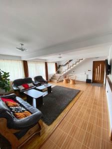 a living room with a couch and a table at Pensiunea Cristiion in Câmpulung +24 photos