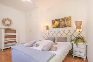 two beds in a white room with at Flores Apartments in Estepona