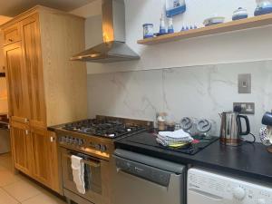 a kitchen with a stove and a counter top at Bayview, Dunmore East, County Waterford - Sleeps 12 persons in Dunmore East