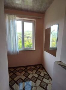 a room with two windows and a tiled floor at MG Guest House in Ijevan