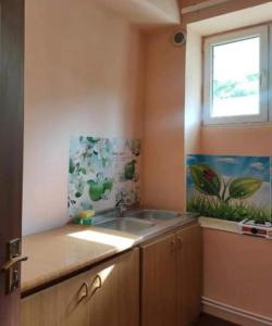 a kitchen with a sink and a window at MG Guest House in Ijevan