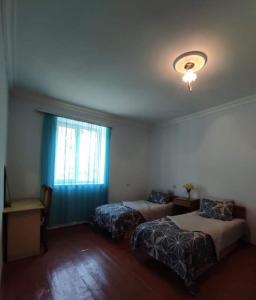 a hotel room with two beds and a window at MG Guest House in Ijevan