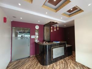 a bar in a room with purple walls at Hotel Embassy Suites - Bandra Kurla Complex - BKC Mumbai in Mumbai