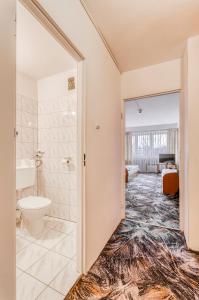 a bathroom with a shower and a toilet and a sink at Hotel Biała Gwiazda in Krakow