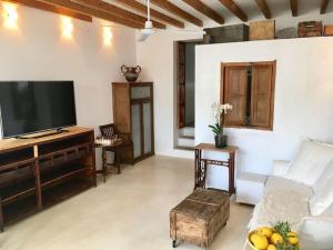 a living room with a flat screen tv and a couch at casita limon in Palma de Mallorca