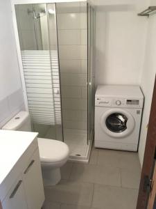 a bathroom with a toilet and a washing machine at casita limon in Palma de Mallorca +20 photos