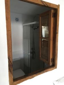 a mirror reflecting a shower in a bathroom at casita limon in Palma de Mallorca