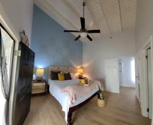a bedroom with a bed and a ceiling fan at Retreat2Jamaica in Runaway Bay