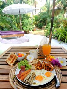 a plate of breakfast food on a table at Jade cottages in Koh Samui 