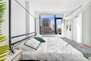 a bedroom with a bed and a large window at Boston VIP Club Quarters by Orchard Group in Cambridge