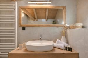 a bathroom with a white sink and a mirror at Kefalonia Luxury Maisonette in Argostoli