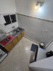 a small kitchen with a sink and a counter at Los Maitenes 888 in Chos Malal