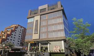 a tall building on the corner of a street at HOTEL APOLLO GRAND A UNIT OF SATYAM ASSOCIATES in Guwahati
