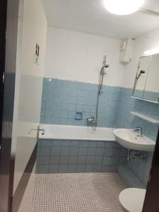 a bathroom with a tub and a sink and a toilet at Gästewohnung in Adolf Grimme Stadt Marl in Marl