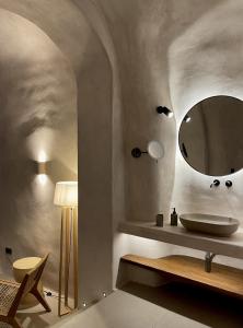a bathroom with a sink and a mirror at Aethra Vegan Caves in Pyrgos