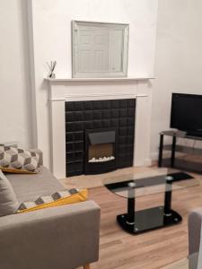 a living room with a couch and a fireplace at *Feel at home* 3bed 2bath house Cleethorpes in Grimsby