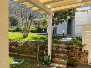 a garden with a bench under a pergola at Villa Oasi Verde in Cinisi