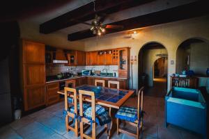 a kitchen with a table and some chairs in it at Villa Getaway with Private Pool in Sannat