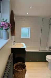 a bathroom with a sink and a shower and a toilet at Spring Crescent Cottage in Rye in Rye