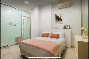a bedroom with a bed and a glass wall at Lovely loft junto a la Giralda in Seville