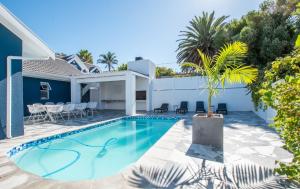 a swimming pool in the backyard of a house at The Fuchsia Collection in Somerset West