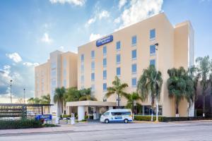 a hotel with a van parked in front of it at City Express by Marriott Leon in León