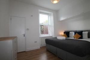 a bedroom with a large bed and a window at Superb One Bedroom Apartment in Dundee in Dundee