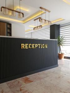 a reception desk with a sign that reads reception at Kriti Hotel Antalya in Antalya