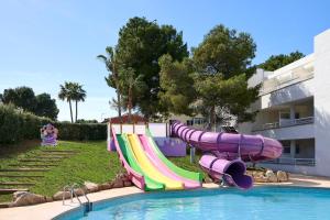 a water slide in a swimming pool in a resort at FERGUS Club Palmanova Park in Palmanova