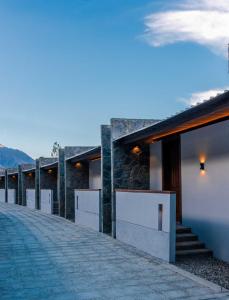 a house with a stone wall and a walkway at Himmel Skardu By Luxus in Skardu