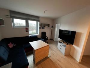 a living room with a couch and a flat screen tv at City View Studio in Wrocław