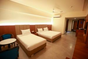 A bed or beds in a room at HOTEL SHUBHAM PALACE