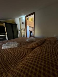 a large bed with two pillows on top of it at PM 6 Via Giovanni Giolitti Guest House in Alghero