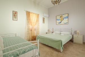 a bedroom with two beds and a window at Aneza in Kremasti
