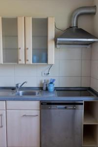 a kitchen with a sink and a stove at Bungalow mit Basketballplatz in Lemgo