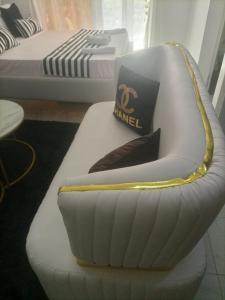 a white couch sitting in a room with a bed at Stylish villa homes in Mombasa +2 photos