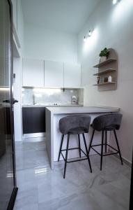 a kitchen with two bar stools and a counter at Apartment Maris in Šibenik