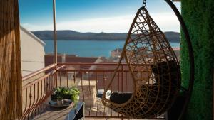 a hammock on a balcony with a view of the water at Apartment Maris in Šibenik