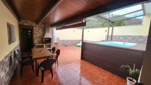 a patio with a table and chairs and a swimming pool at Casa LA JOYA in Las Palmas de Gran Canaria