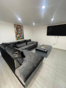 a living room with a couch and a flat screen tv at Piscadera bay resort 15c in Willemstad