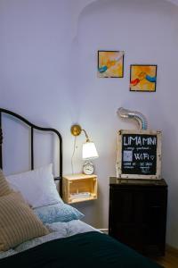 a bedroom with a bed and a lamp on a table at Lima Mini - cozy apartment - in Győr