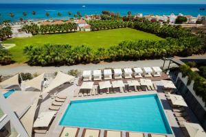 an aerial view of a resort with a swimming pool and chairs at At Herbal Boutique Hotel & Spa in Protaras