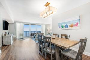 a dining room and living room with a table and chairs at Sea Colony - 1403N Edgewater House Rd. in Bethany Beach