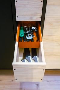 a drawer in a wooden cabinet filled with tools at Lima Mini - cozy apartment - in Győr