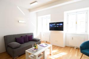 a living room with a couch and a table at Designer apartment - centrally located in Vienna